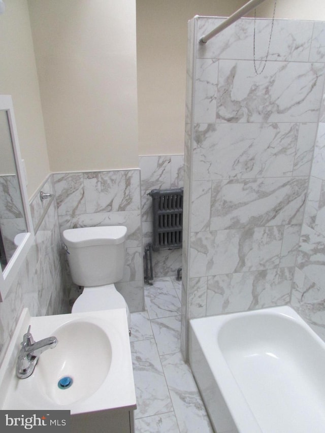 full bathroom featuring toilet, shower / bath combination, sink, and tile walls