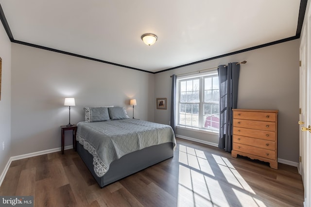 bedroom featuring crown molding and dark wood-type flooring