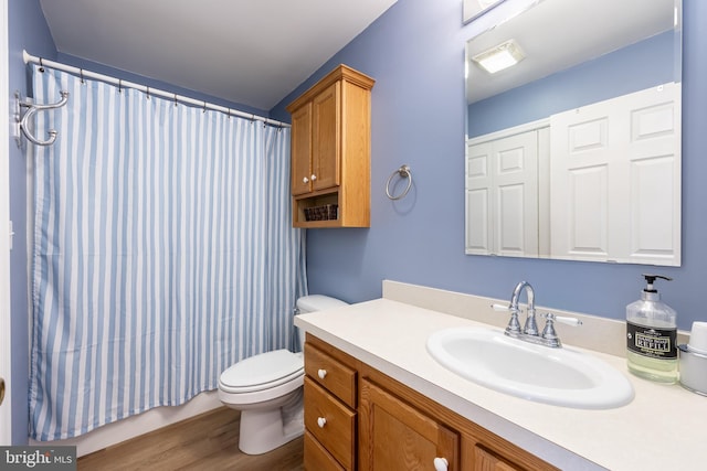 bathroom with vanity, hardwood / wood-style floors, walk in shower, and toilet