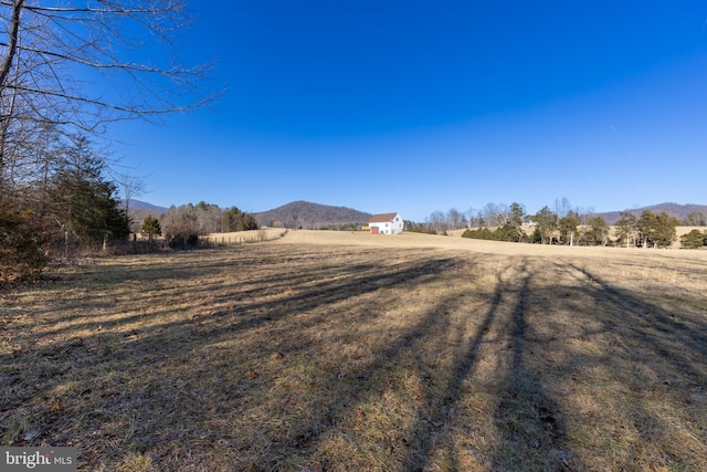 view of yard featuring a rural view and a mountain view