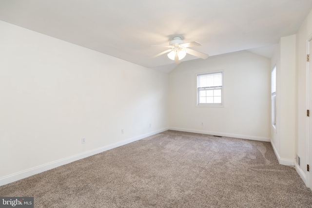 carpeted empty room with lofted ceiling and ceiling fan