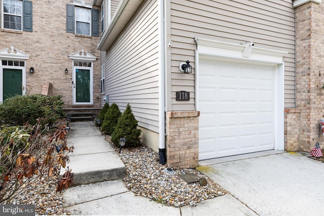 doorway to property with a garage