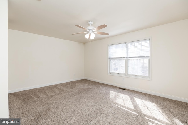 unfurnished room with ceiling fan and carpet flooring