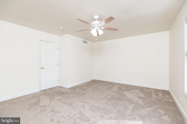 carpeted empty room featuring ceiling fan