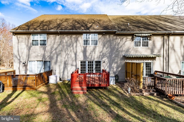 rear view of house featuring a yard and a deck