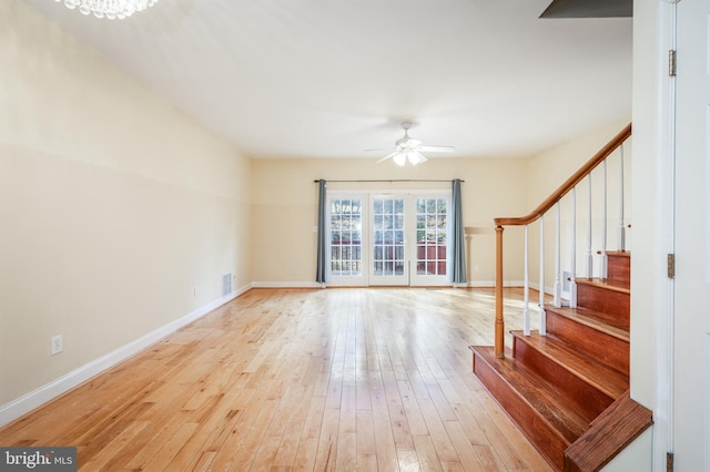 unfurnished living room featuring ceiling fan and light wood-type flooring