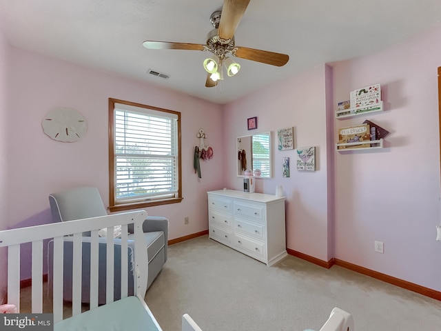 bedroom with light carpet, baseboards, visible vents, and a ceiling fan