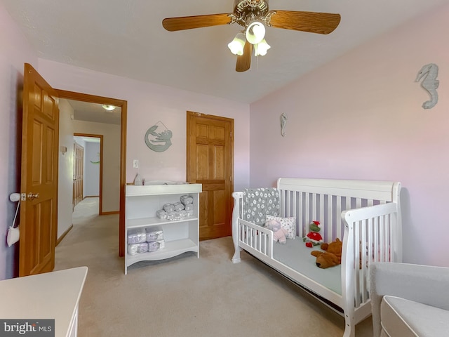 bedroom with a ceiling fan and light colored carpet