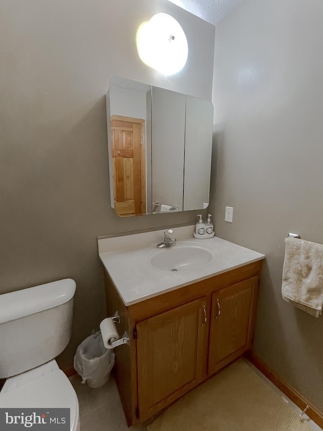 bathroom featuring toilet and vanity