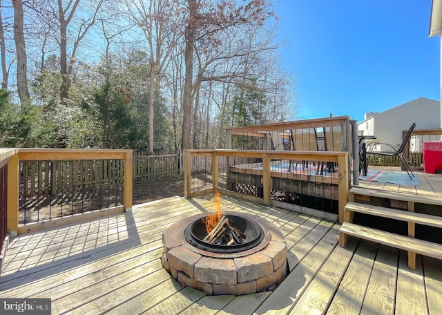 wooden deck with an outdoor fire pit