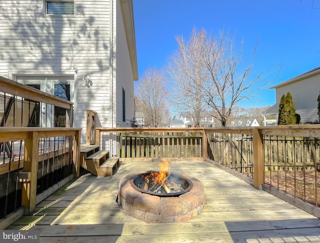 wooden terrace featuring an outdoor fire pit