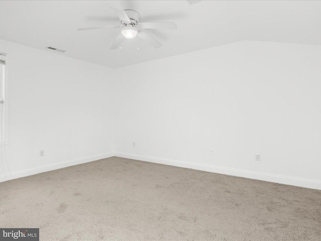 empty room featuring ceiling fan and carpet