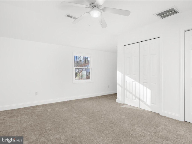 unfurnished bedroom featuring light carpet and ceiling fan