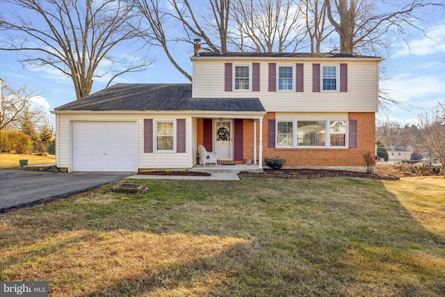 view of front of property featuring a garage and a front lawn