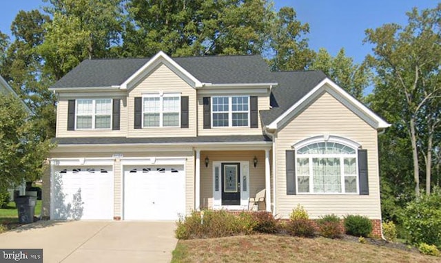 view of front of home featuring concrete driveway and an attached garage