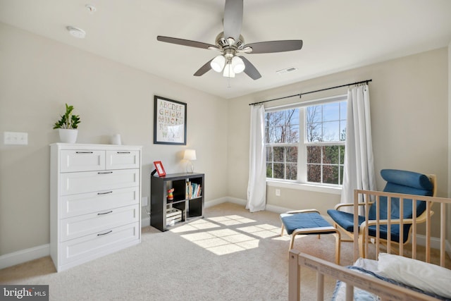 living area with visible vents, light carpet, and baseboards