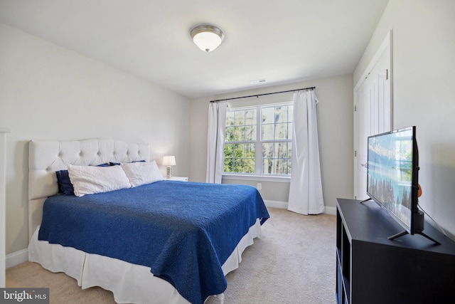 carpeted bedroom with baseboards