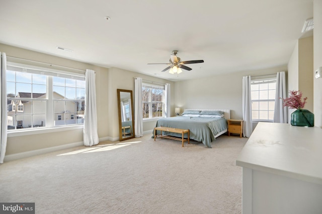 carpeted bedroom featuring visible vents, a ceiling fan, and baseboards