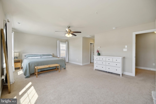 bedroom featuring visible vents, light colored carpet, baseboards, and ceiling fan