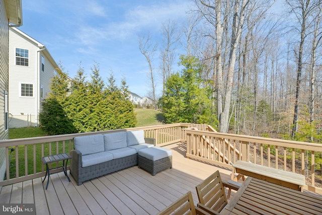 deck featuring a lawn and outdoor lounge area