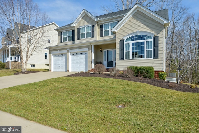 view of front of home featuring a front yard, an attached garage, and driveway