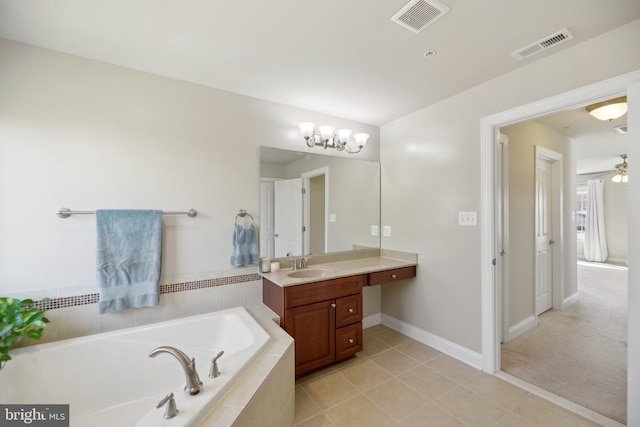 bathroom with a bath, visible vents, tile patterned floors, and vanity