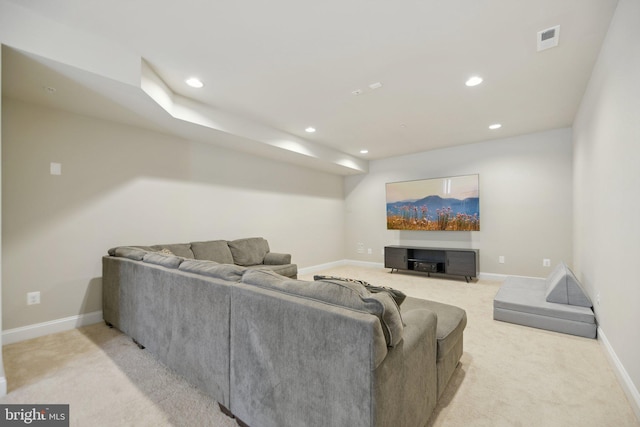 living area featuring recessed lighting, visible vents, baseboards, and light colored carpet