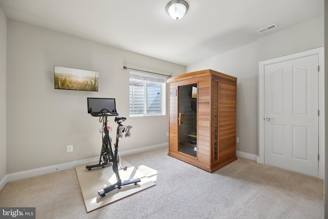 exercise area featuring carpet flooring, visible vents, and baseboards