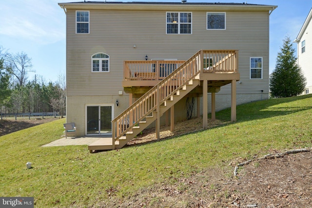 back of house featuring stairway, a lawn, and a deck