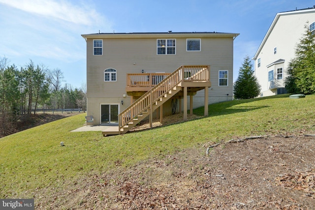 rear view of property with a lawn, a wooden deck, and stairs