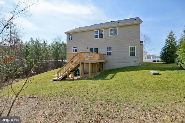 rear view of property with a lawn, a deck, and stairs