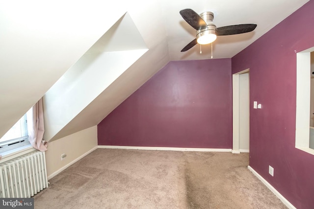 bonus room with vaulted ceiling, carpet floors, radiator heating unit, and baseboards