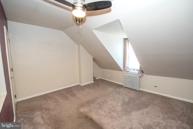 bonus room with baseboards, a ceiling fan, radiator, lofted ceiling, and carpet floors