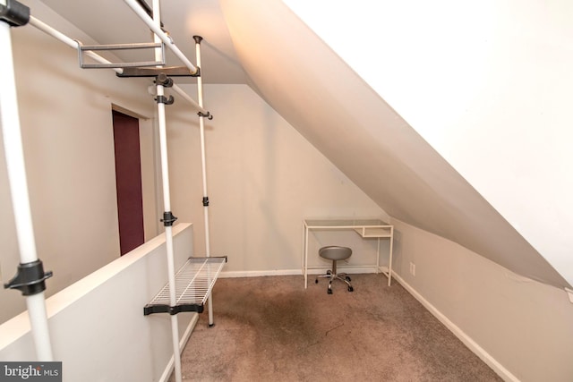 home office featuring carpet, baseboards, and vaulted ceiling