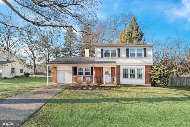 view of front property featuring a porch, a garage, and a front lawn