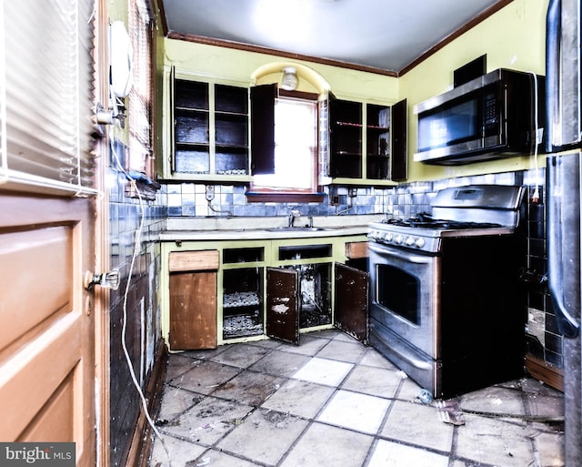 kitchen with ornamental molding, appliances with stainless steel finishes, and sink