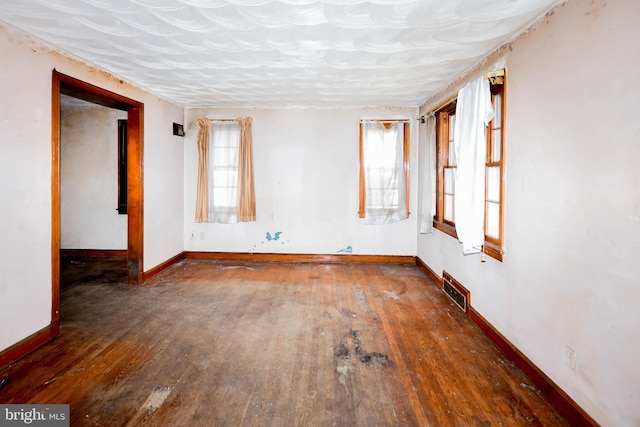 empty room with dark hardwood / wood-style floors