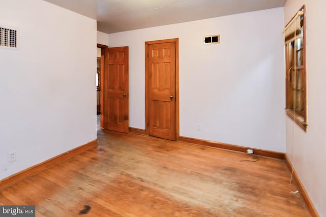 unfurnished room with light hardwood / wood-style flooring