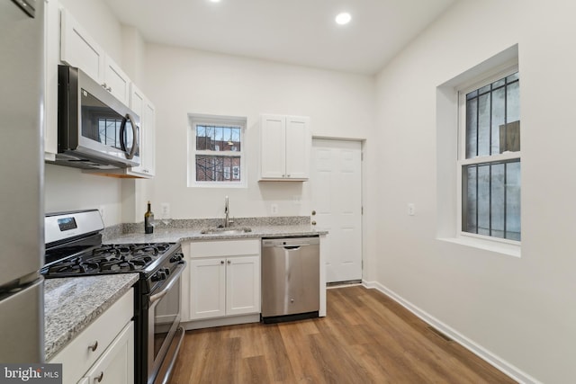 kitchen featuring sink, white cabinets, and appliances with stainless steel finishes