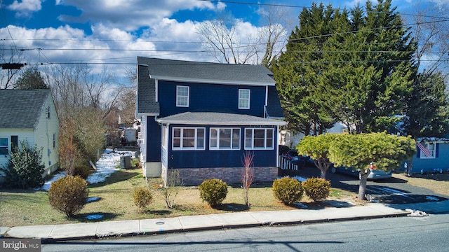 view of front of property with a shingled roof and central AC unit