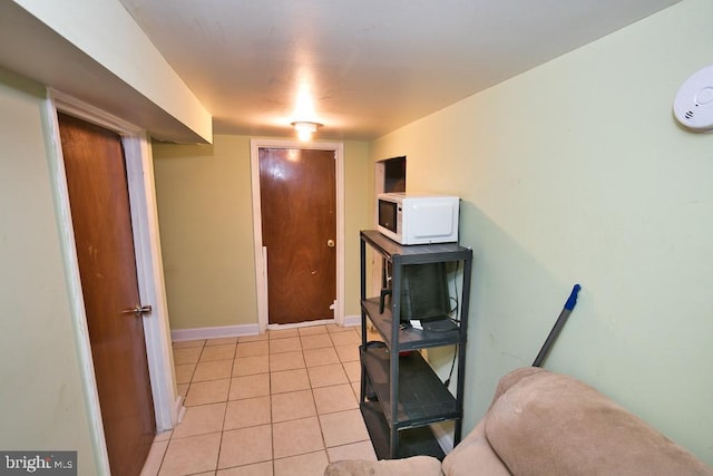 interior space featuring baseboards and light tile patterned floors