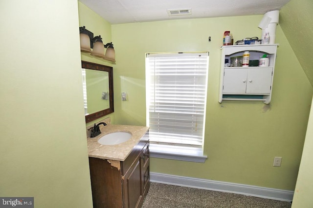 bathroom with baseboards, visible vents, and vanity