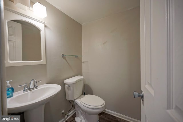 bathroom with sink, wood-type flooring, and toilet