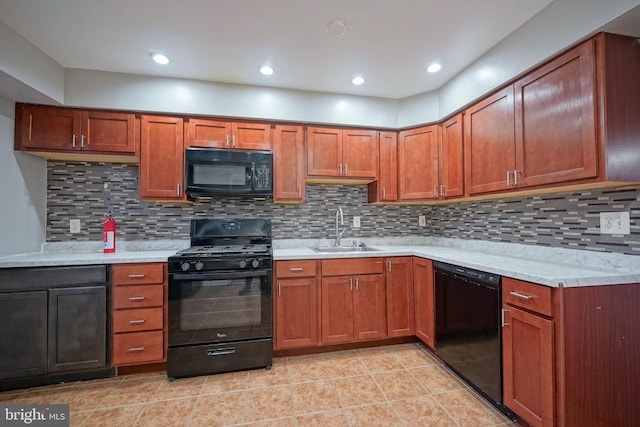 kitchen featuring backsplash, light tile patterned floors, sink, and black appliances