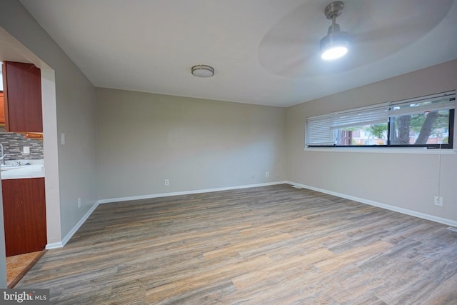 spare room with wood-type flooring and ceiling fan