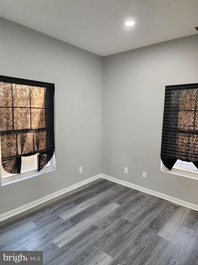 spare room featuring dark wood-type flooring