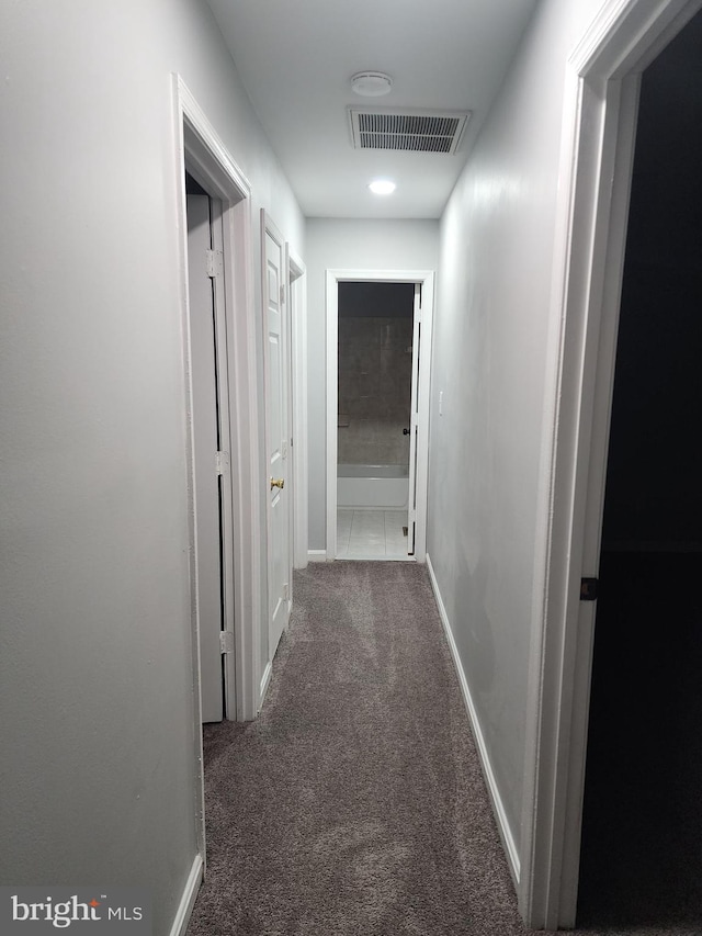 corridor with dark colored carpet