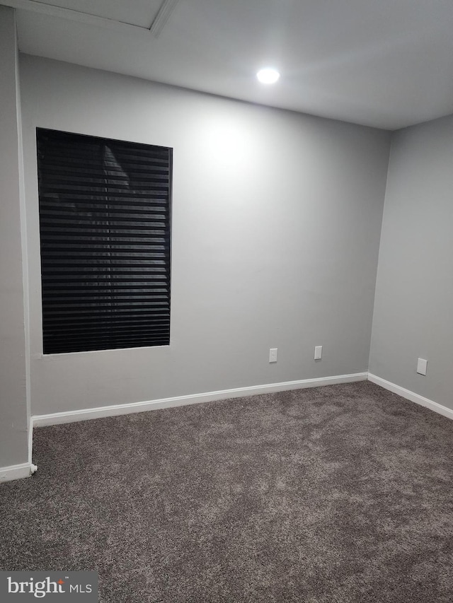 empty room featuring dark carpet