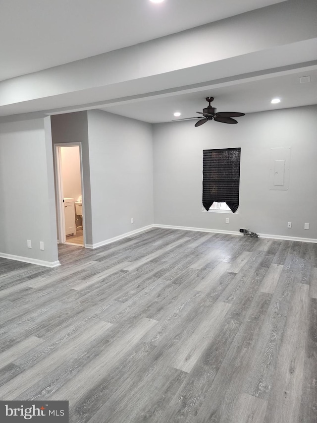 unfurnished living room featuring ceiling fan and light wood-type flooring