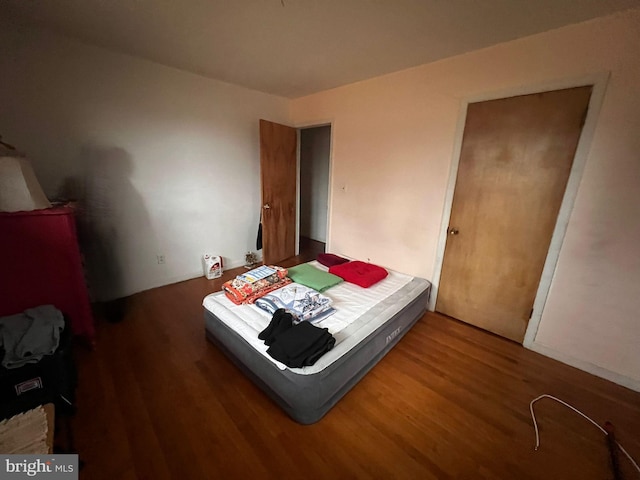 bedroom featuring dark hardwood / wood-style flooring